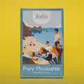 Box of Josh's Milk Chocolate Buttons, it is a blue box an with illustration of a beach picnic scene, it is placed on a yellow background.